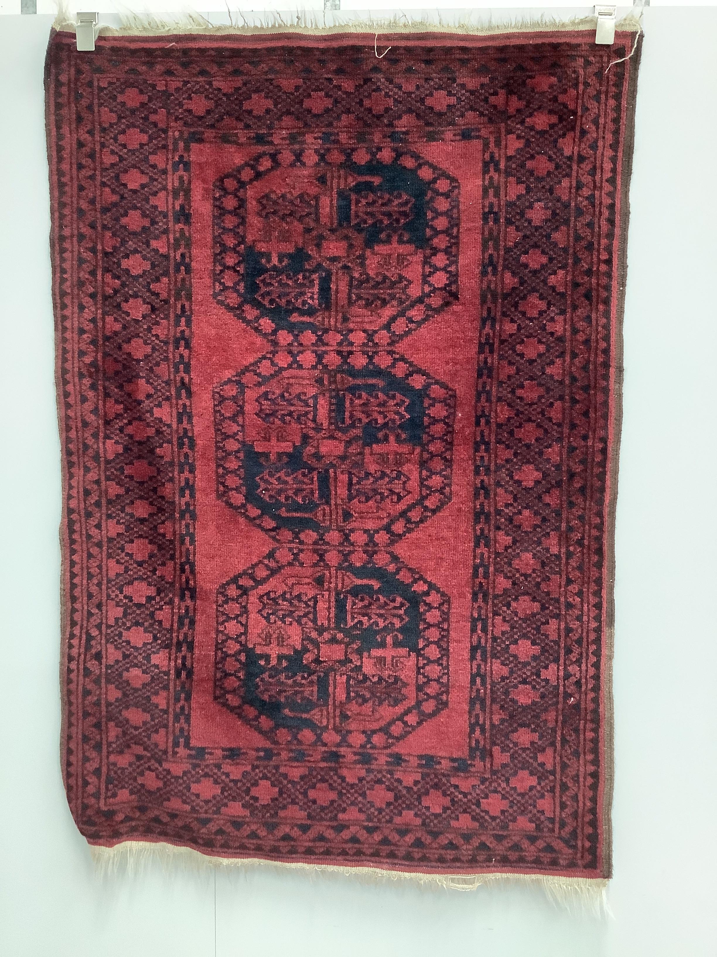 Two Afghan red ground rugs, larger 170 x 120cm